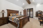 Master bedroom has a King sized bed, fireplace and balcony
